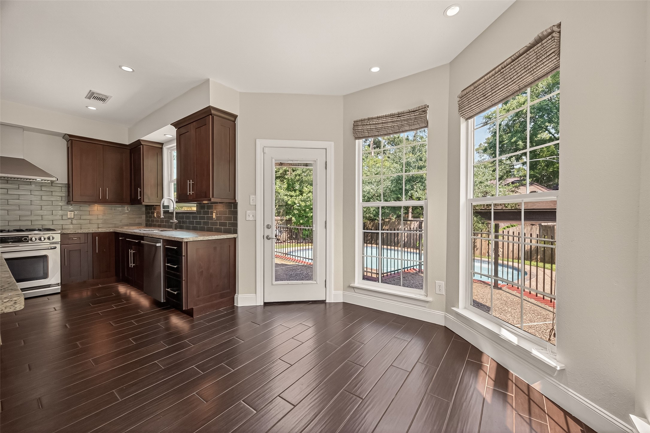 6131 Hampton Way Court Spring, TX 77389 - Photo 17 of 50 a kitchen with stainless steel appliances granite countertop a stove a sink and a large window