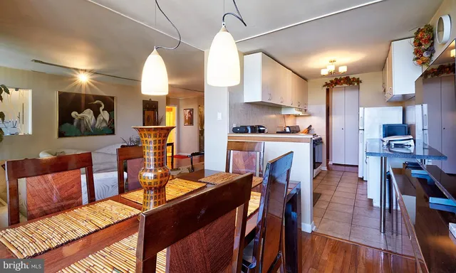 a view of a kitchen with dining room and wooden floor
