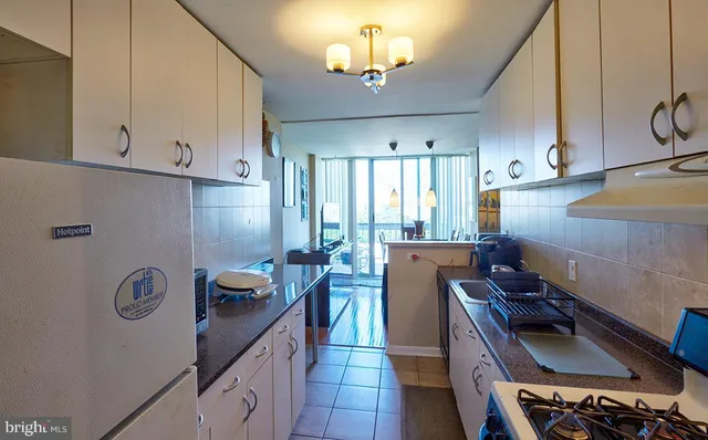 a kitchen with sink refrigerator and stove