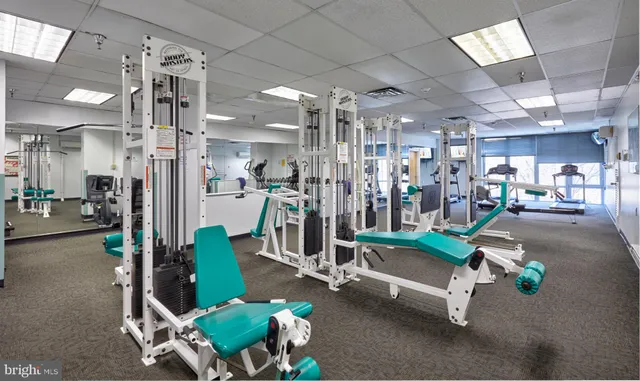 a view of a backyard with a patio and a fire pit