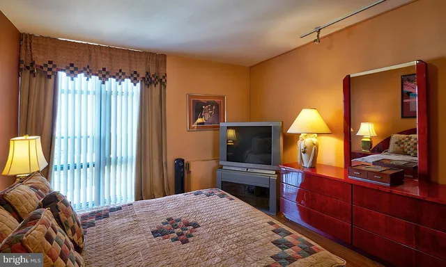 a bedroom with a bed and a dresser