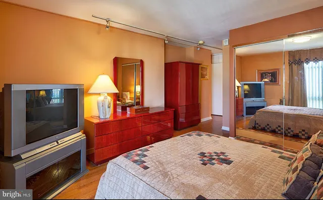 a bed room with a bed and a television