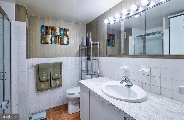 a bathroom with a toilet sink and mirror