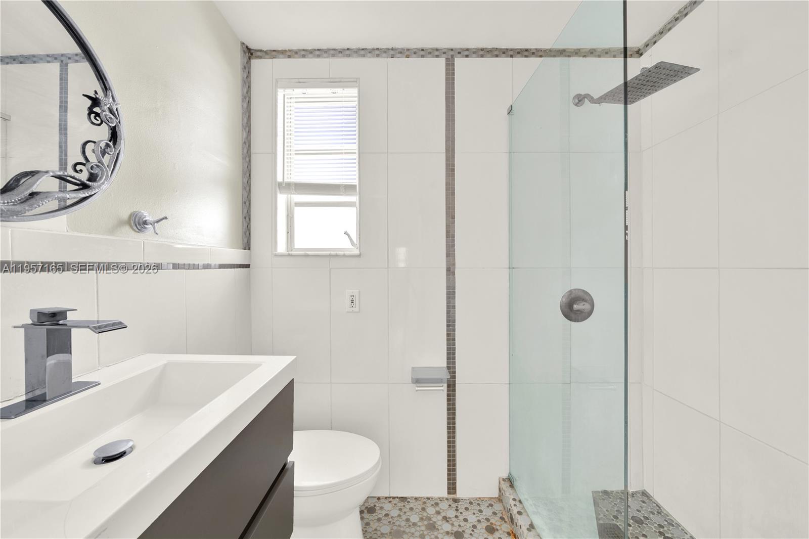 610 8th Street, Unit 102R Miami Beach, FL 33139 - Photo 17 of 22 a bathroom with a sink a toilet and shower