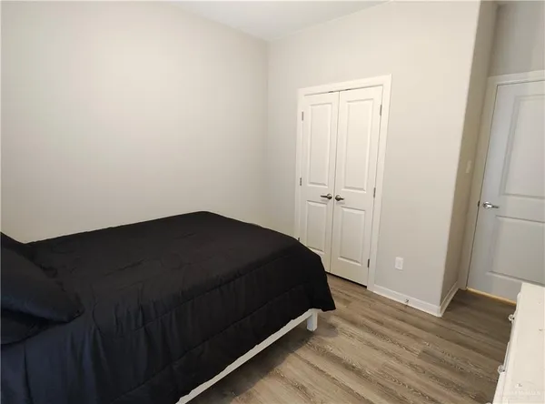 an empty room with wooden floor