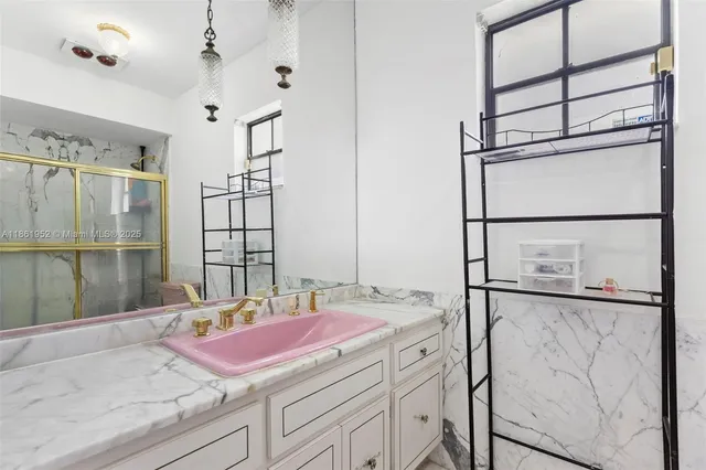 a bathroom with a sink vanity tub and shower