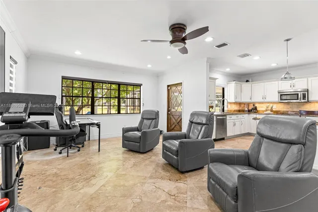 a bedroom with furniture and a flat screen tv