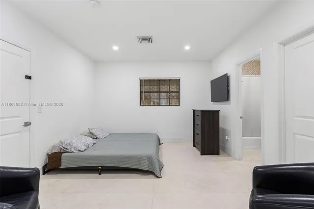 a bathroom with a sink vanity mirror and toilet
