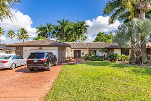 a front view of house with yard and green space