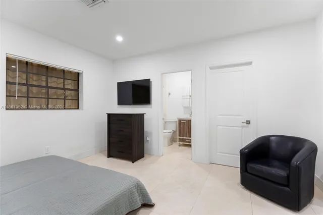 a view of an ocean with a big yard and palm trees