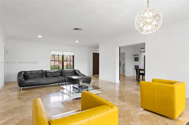a large white kitchen with lots of furniture a sink appliances and a dining table