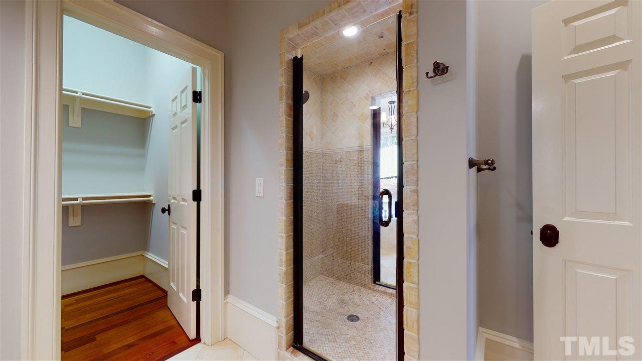 10508 Charmford Way Raleigh, NC 27615 - Photo 18 of 30 His and Her's bathrooms and closets. The shower connects the two bathrooms.