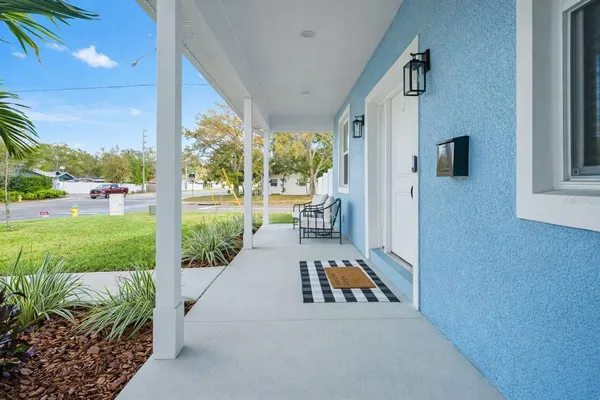 a view of a porch with furniture and garden