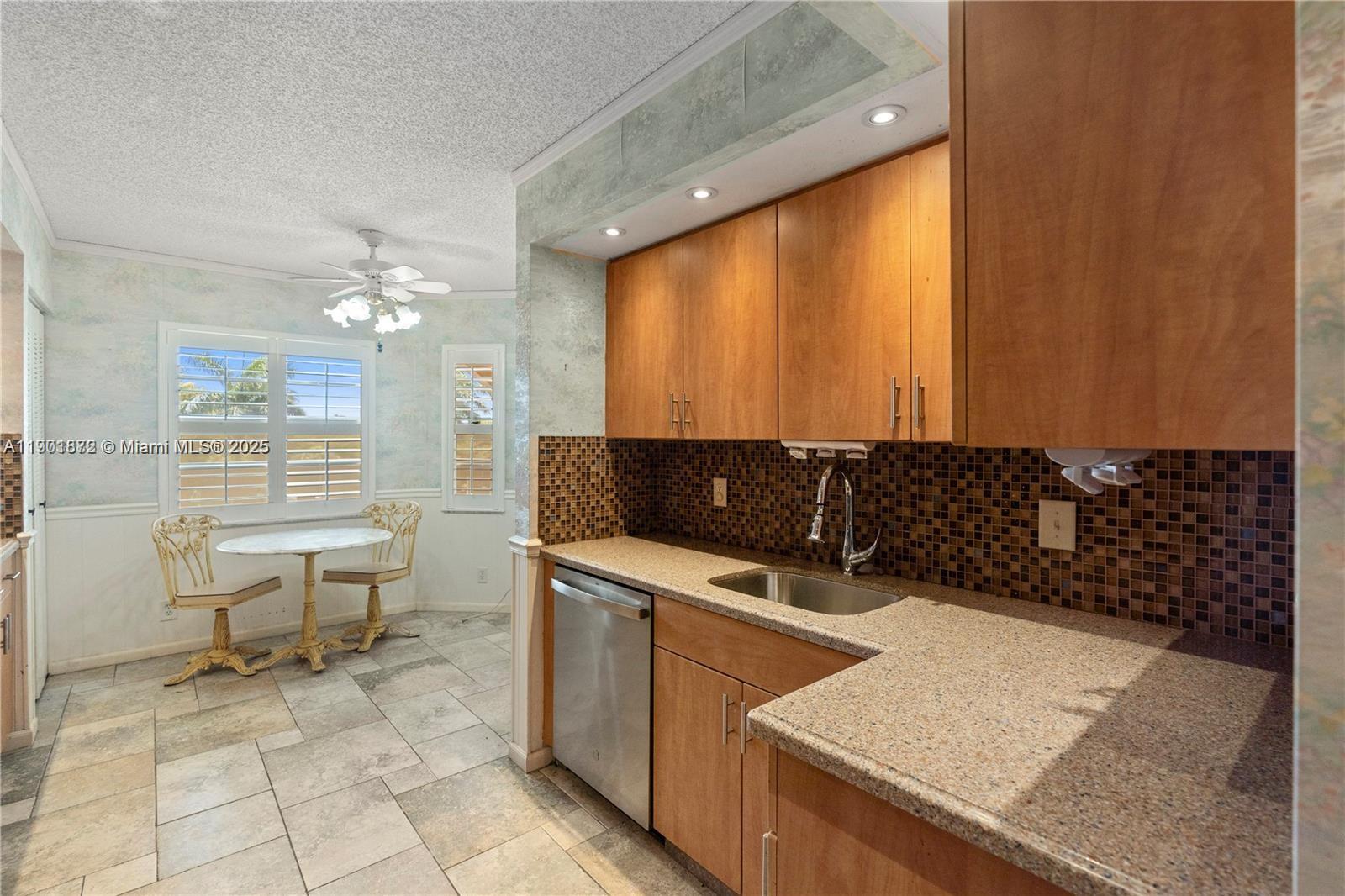 1603 Abaco Drive, Unit K4 Coconut Creek, FL 33066 - Photo 11 of 36 a kitchen that has a sink and a stove