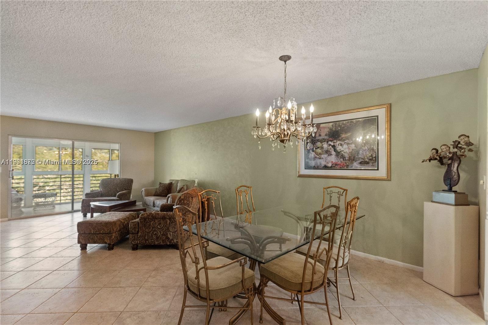 1603 Abaco Drive, Unit K4 Coconut Creek, FL 33066 - Photo 13 of 36 a living room with furniture and a chandelier