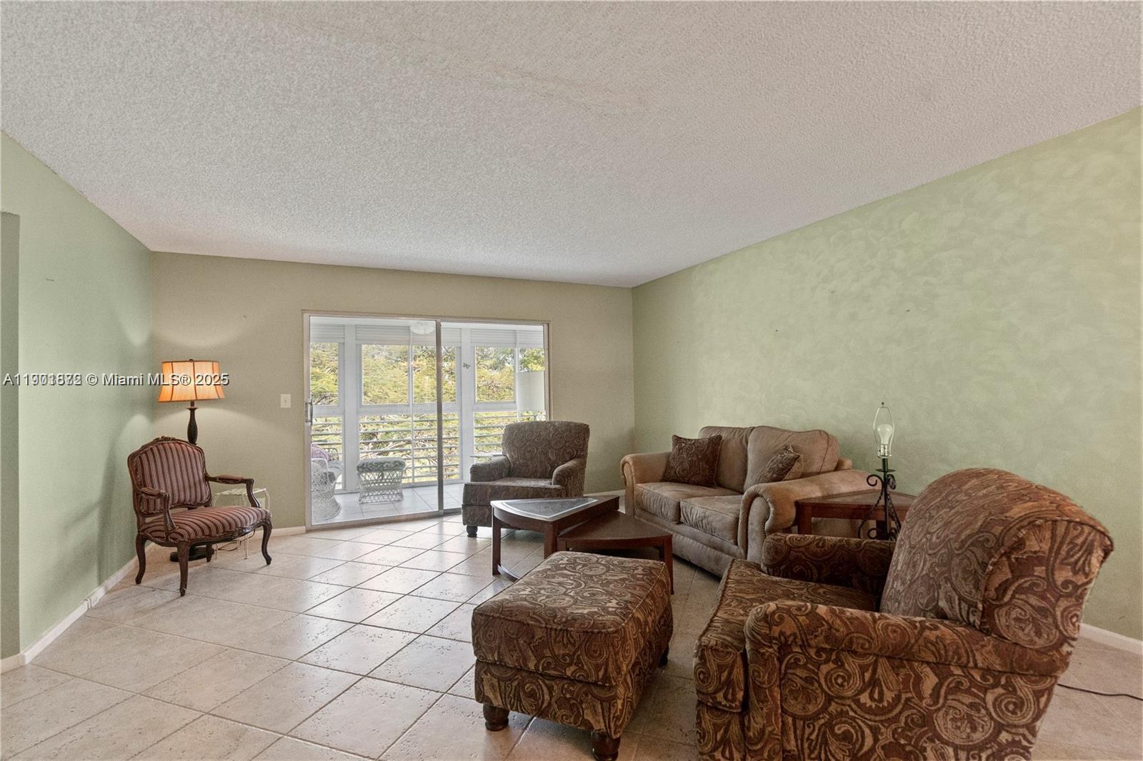 1603 Abaco Drive, Unit K4 Coconut Creek, FL 33066 - Photo 14 of 36 a living room with furniture and a window