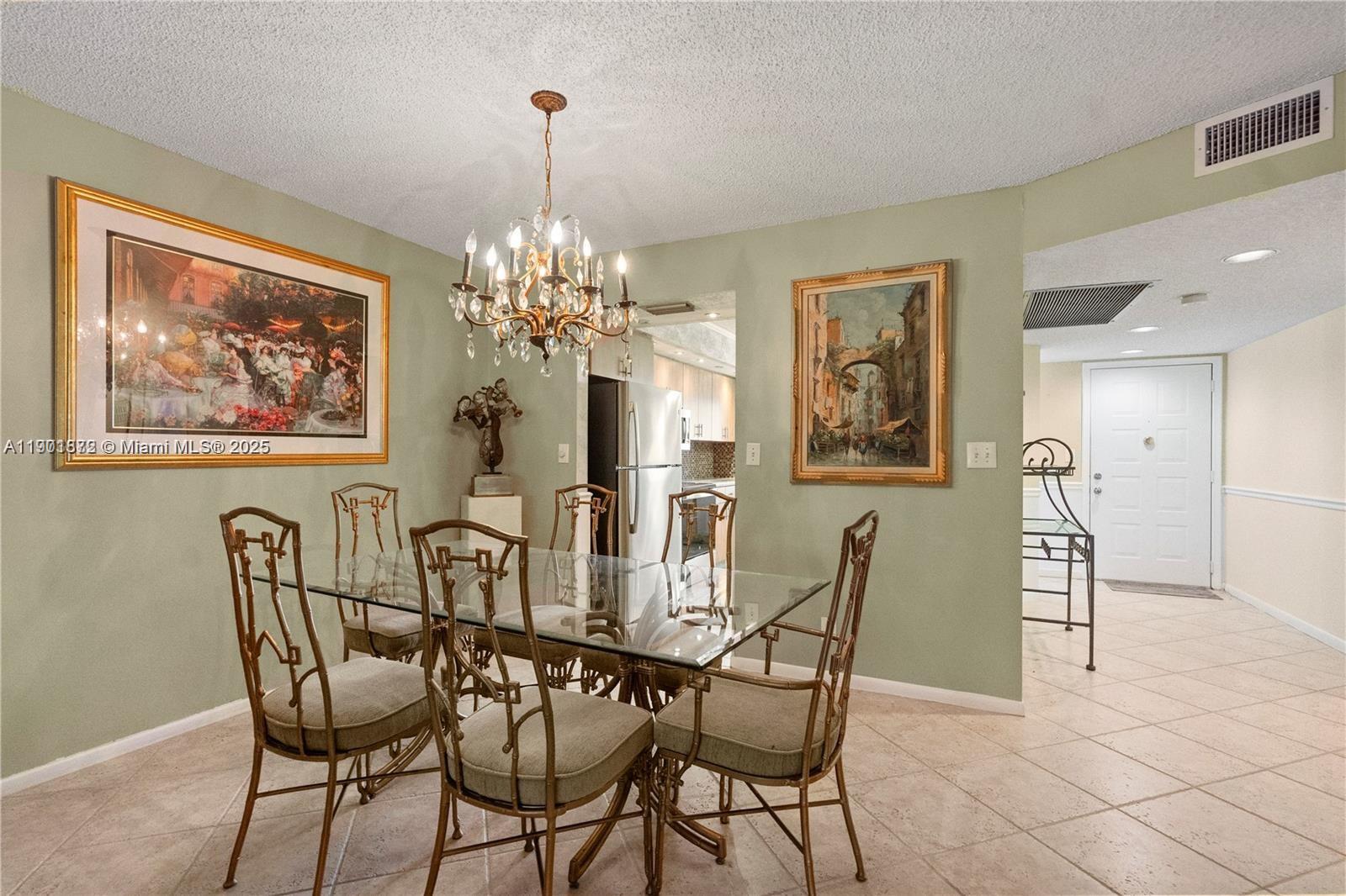 1603 Abaco Drive, Unit K4 Coconut Creek, FL 33066 - Photo 15 of 36 a view of a dining room with furniture and chandelier