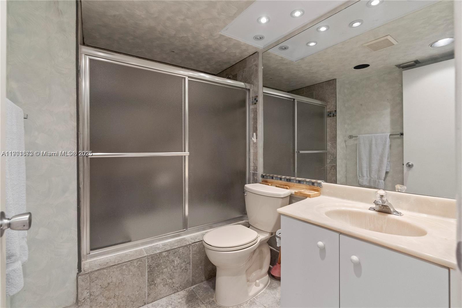 1603 Abaco Drive, Unit K4 Coconut Creek, FL 33066 - Photo 20 of 36 a bathroom with a toilet sink and shower