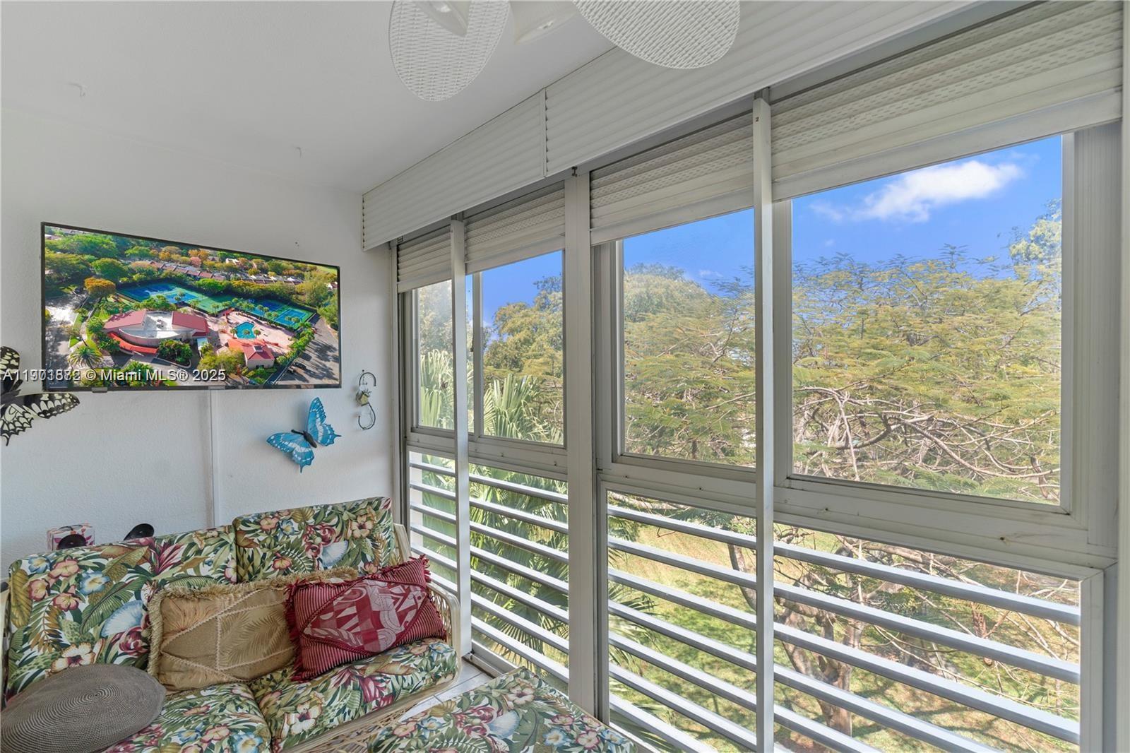 1603 Abaco Drive, Unit K4 Coconut Creek, FL 33066 - Photo 27 of 36 a living room with furniture and a flat screen tv
