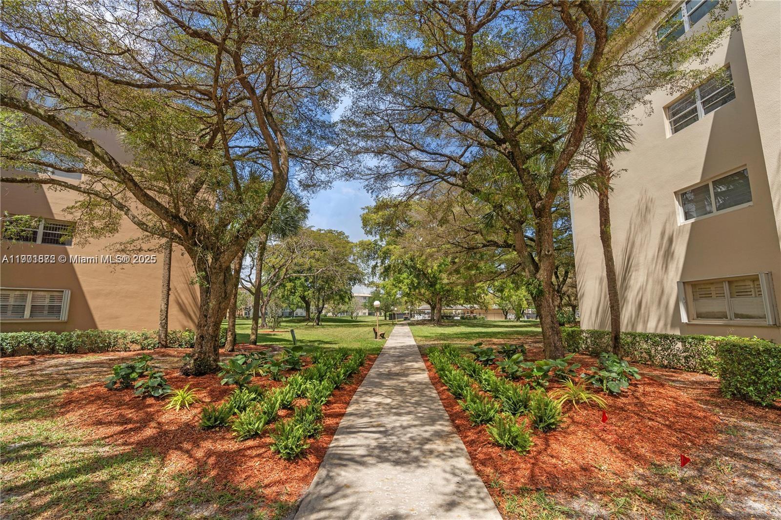 1603 Abaco Drive, Unit K4 Coconut Creek, FL 33066 - Photo 29 of 36 a front view of a house with a yard