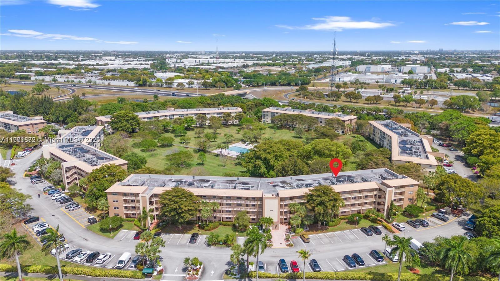 1603 Abaco Drive, Unit K4 Coconut Creek, FL 33066 - Photo 36 of 36 an aerial view of a city with lots of residential buildings ocean and mountain view in back