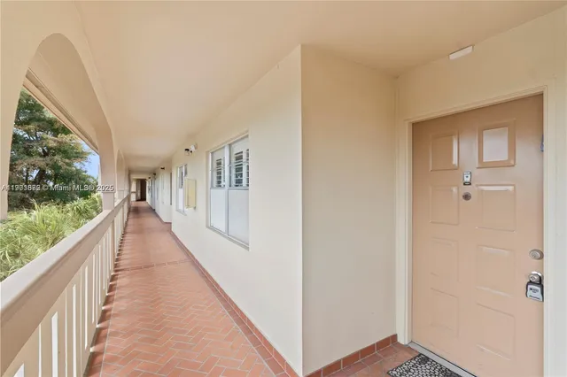 a view of a hallway with wooden floor and stairs