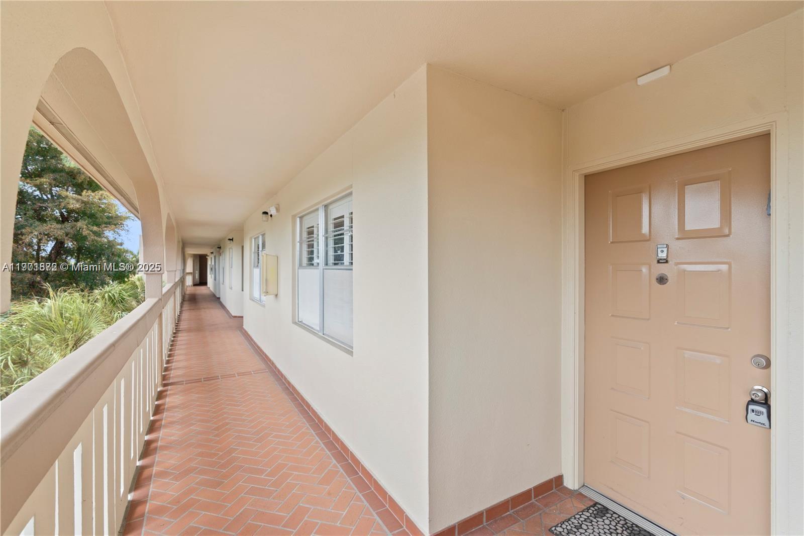 1603 Abaco Drive, Unit K4 Coconut Creek, FL 33066 - Photo 5 of 36 a view of a hallway with wooden floor and stairs