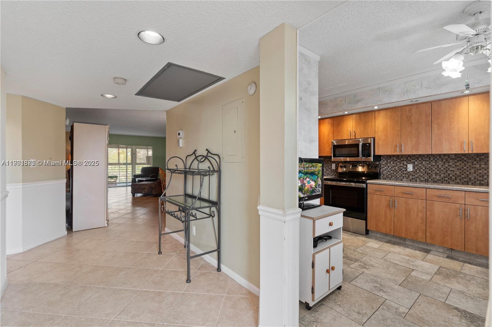 1603 Abaco Drive, Unit K4 Coconut Creek, FL 33066 - Photo 6 of 36 a kitchen with refrigerator and cabinets