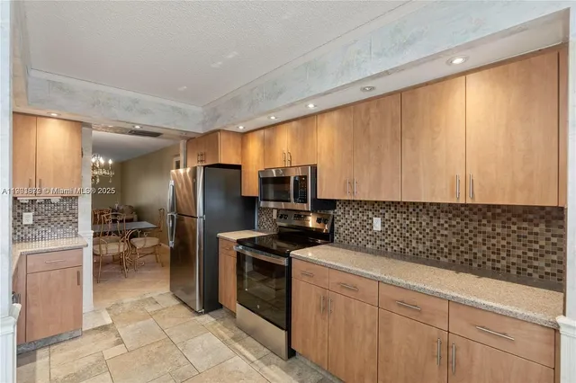 a kitchen with a sink cabinets and stainless steel appliances