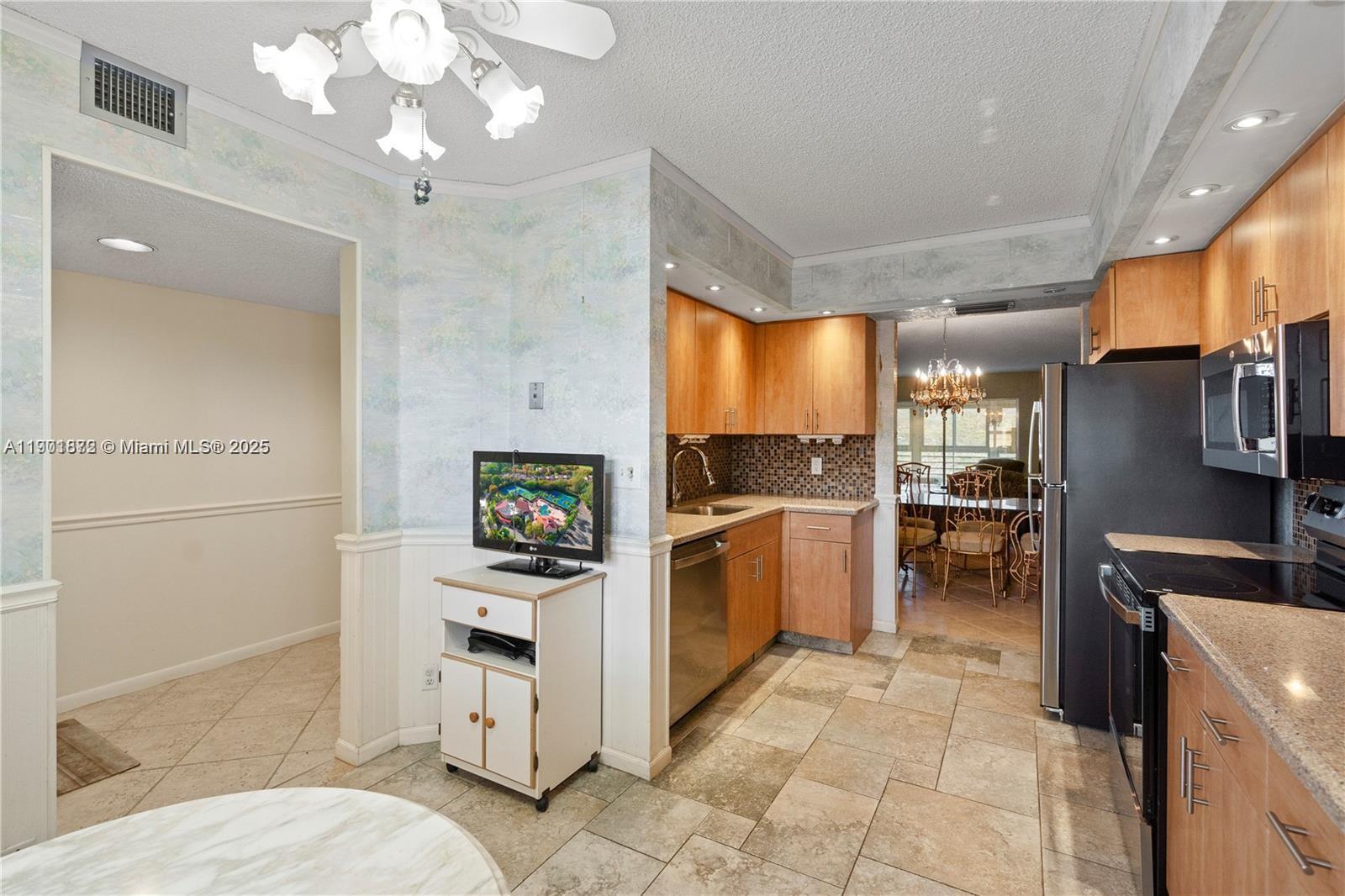 1603 Abaco Drive, Unit K4 Coconut Creek, FL 33066 - Photo 8 of 36 a kitchen with a refrigerator and a sink