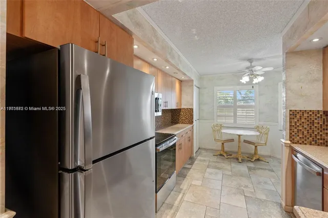 a kitchen that has a sink and a stove