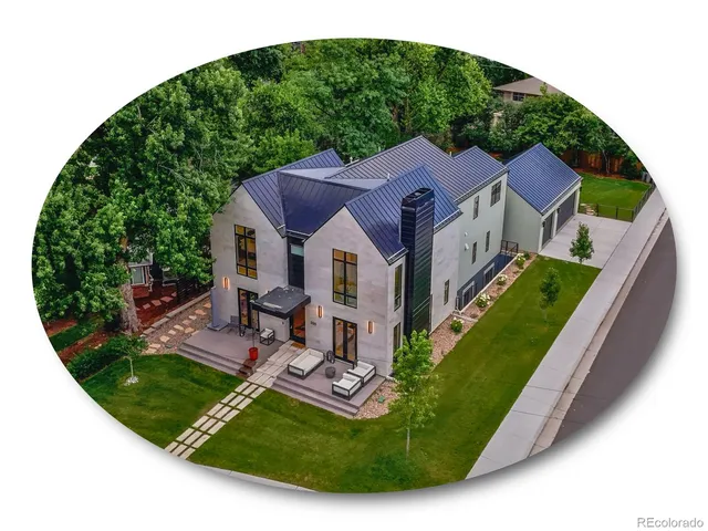 an aerial view of a house with a yard table and chairs