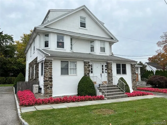 a front view of house with yard and green space