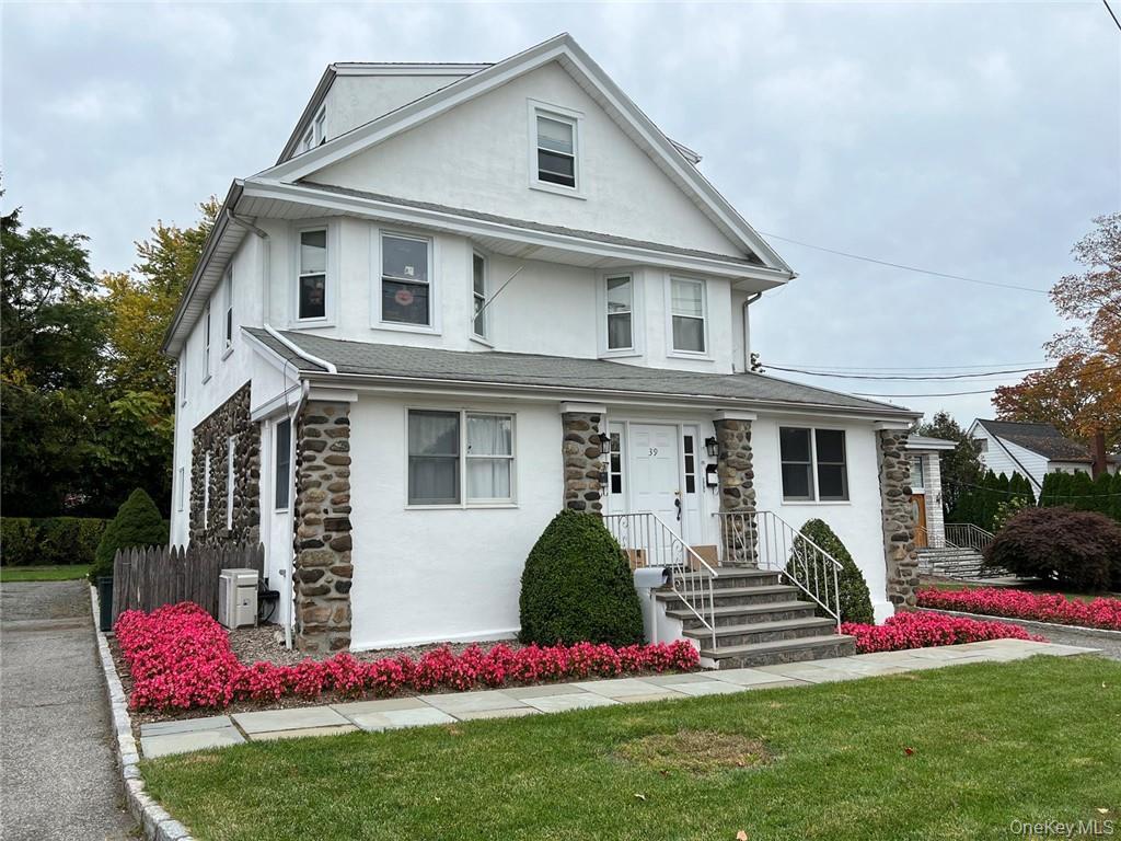 39 Wilmot Road, Unit 1 Scarsdale, NY 10583 - Photo 1 of 18 a front view of house with yard and green space