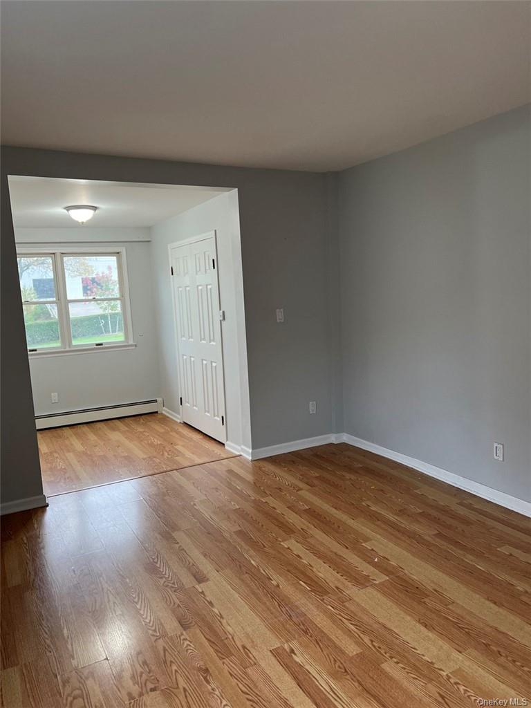 39 Wilmot Road, Unit 1 Scarsdale, NY 10583 - Photo 12 of 18 an empty room with wooden floor and windows