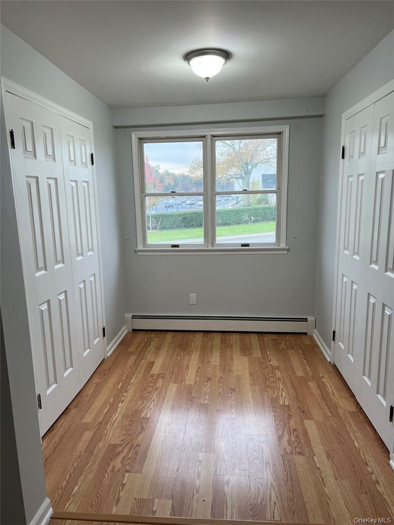 39 Wilmot Road, Unit 1 Scarsdale, NY 10583 - Photo 13 of 18 an empty room with wooden floor and windows