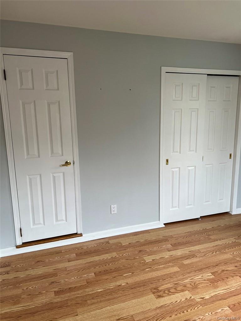 39 Wilmot Road, Unit 1 Scarsdale, NY 10583 - Photo 15 of 18 a view of an empty room with wooden floor