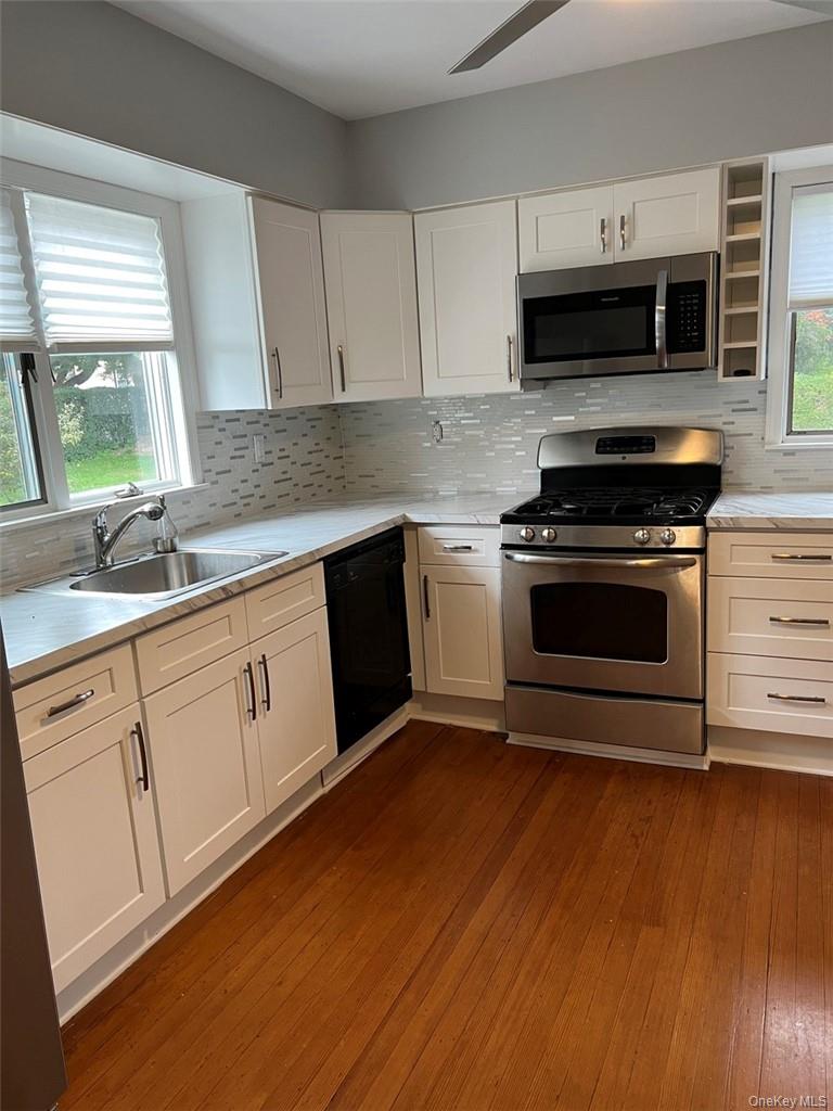 39 Wilmot Road, Unit 1 Scarsdale, NY 10583 - Photo 2 of 18 a kitchen with sink a microwave and cabinets