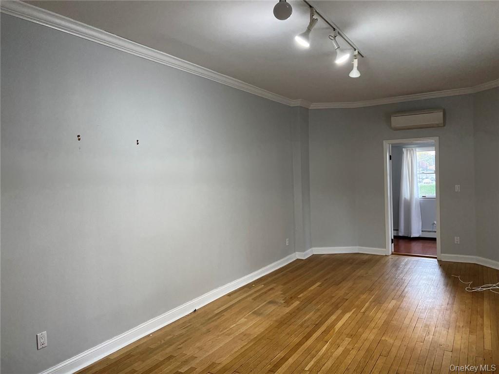 39 Wilmot Road, Unit 1 Scarsdale, NY 10583 - Photo 6 of 18 an empty room with wooden floor and windows