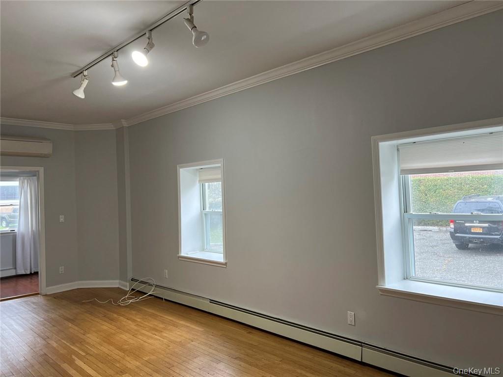 39 Wilmot Road, Unit 1 Scarsdale, NY 10583 - Photo 7 of 18 an empty room with wooden floor and windows