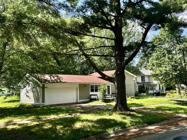 a yellow house in middle of the forest