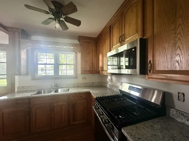 a kitchen with a stove a sink and a microwave