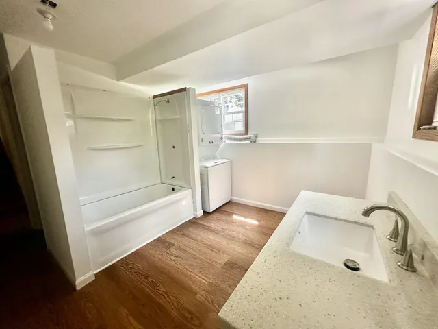 a bathroom with a bathtub and a shower