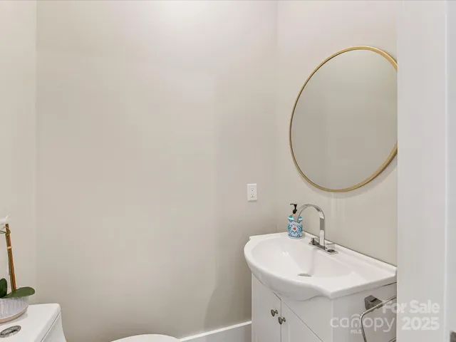 a bathroom with a sink a mirror and a toilet