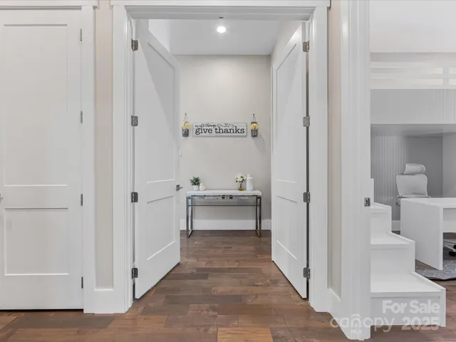 a view of a hallway with bathroom and sink