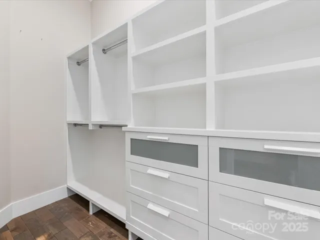a view of walk in closet with empty racks