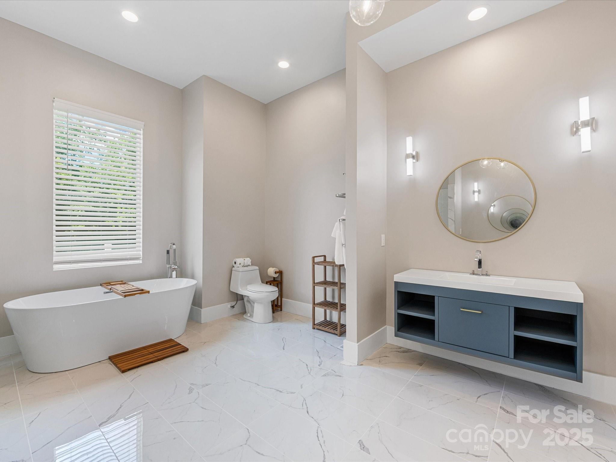 4315 Hartis Grove Church Road Indian Trail, NC 28079 - Photo 28 of 44 a spacious bathroom with a double vanity sink a mirror and a bathtub