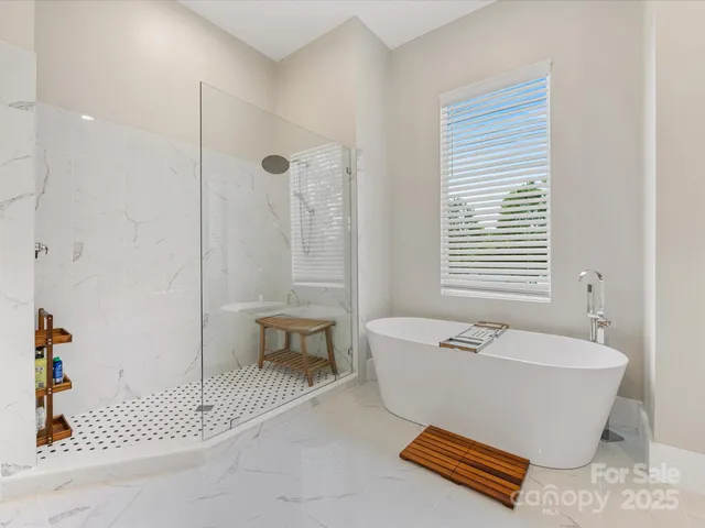 a spacious bathroom with a bathtub and next to a window