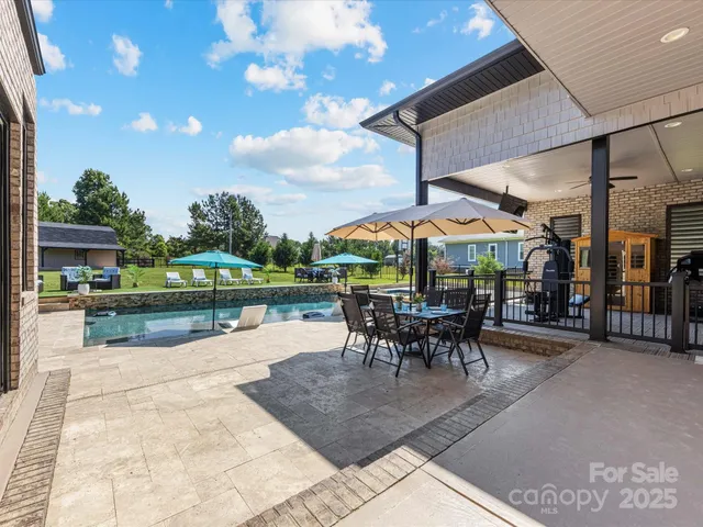 a view of a patio with a table and chairs