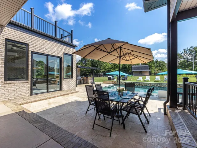a view of a patio with a table and chairs